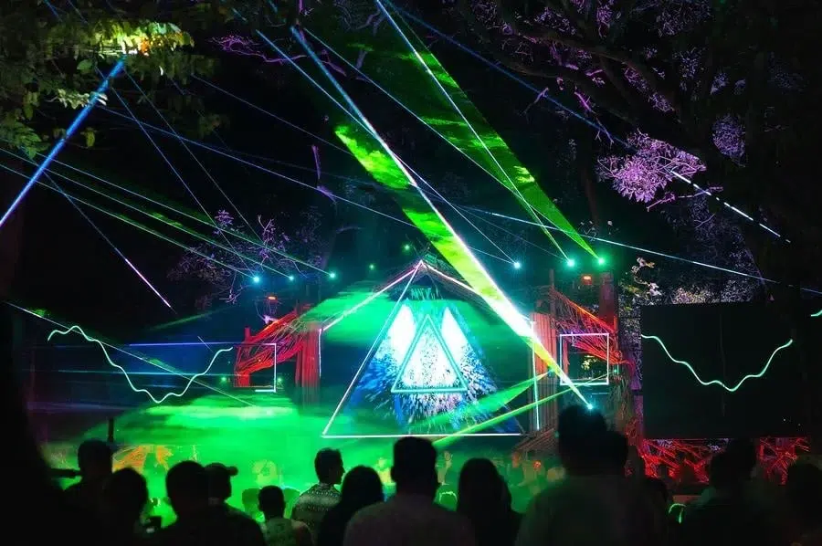 festivals in costa rica-63 | Pacific Photography Nighttime concert with a triangular-lit stage and green laser beams crossing over a crowd.