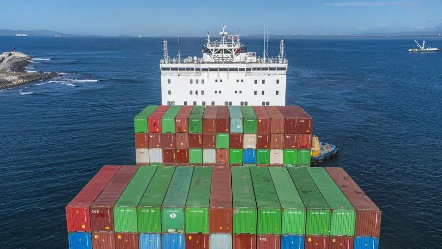 brands business and corporate photography -25 | Pacific Photography Container ship at sea with tall stacks of red, green, blue shipping containers and a white bridge.