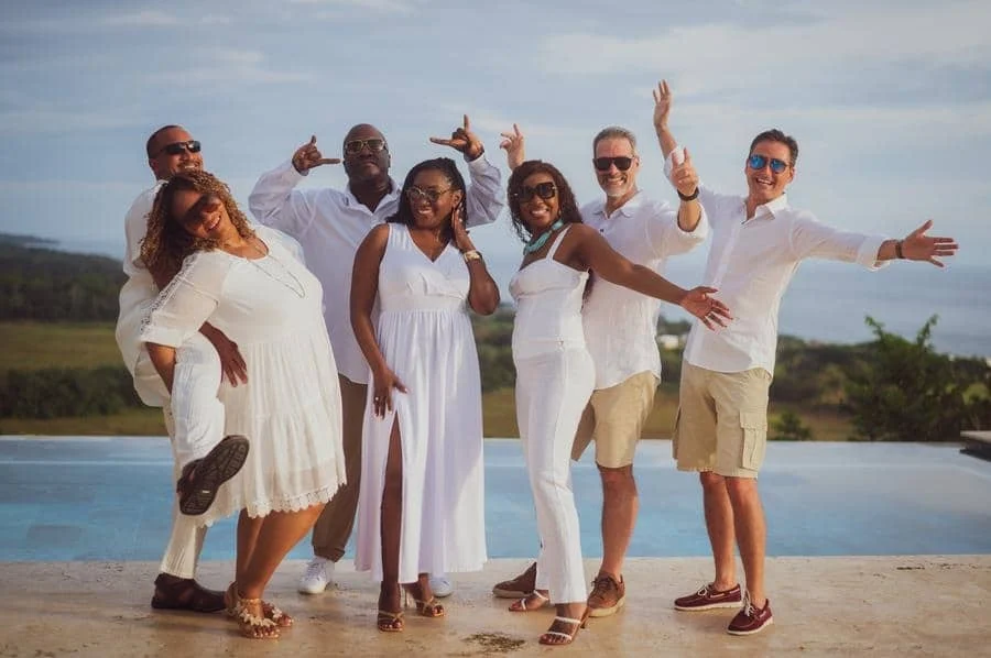 people and lifestyle photography -3 | Pacific Photography Diverse group of friends dressed in white posing playfully by a pool on a sunny day.