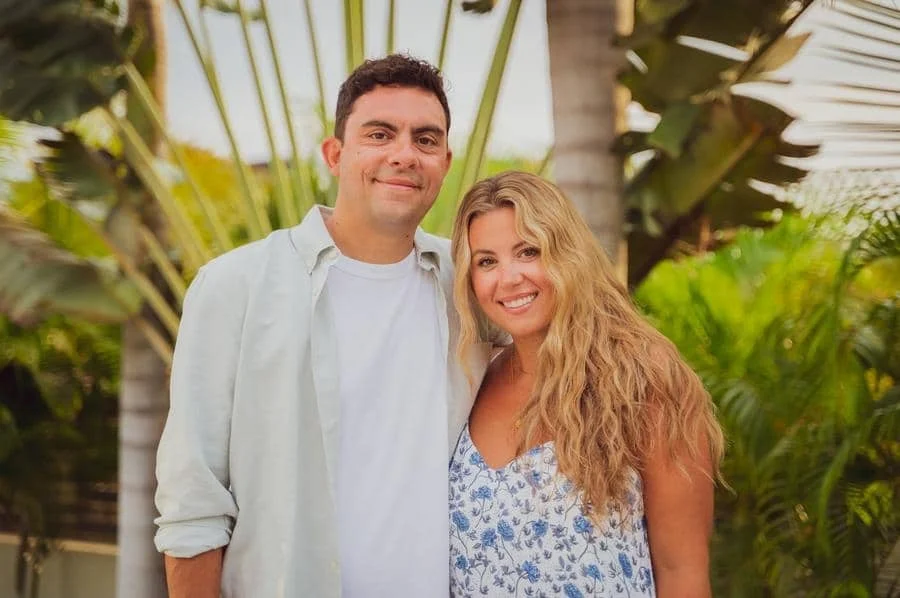 people and lifestyle photography -46 | Pacific Photography Man and woman smile at the camera while posing outdoors among tropical plants.
